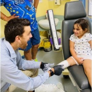 Young child receiving advice around leg amputation